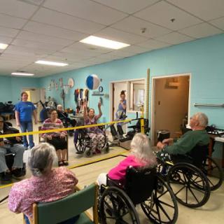 Seniors enjoying a recreational activity in a community center, promoting social interaction and engagement.