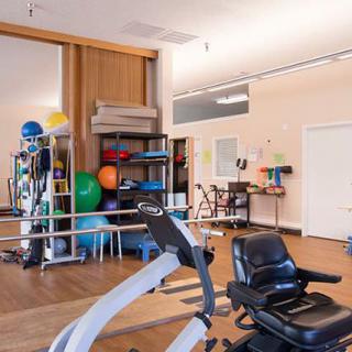 A well-equipped gym with various exercise machines and fitness tools.
