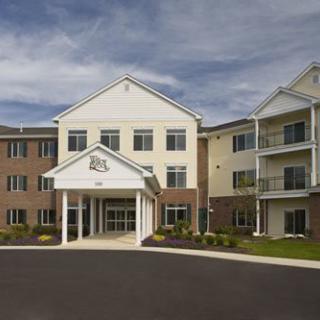 A modern three-story residential building with an inviting entrance.