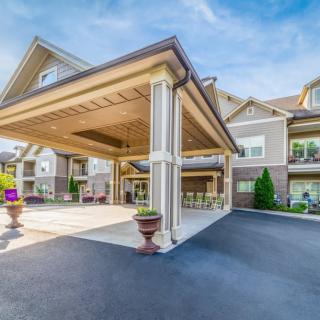A well-maintained residential building with a covered entrance and driveway.