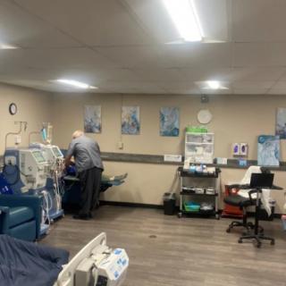 A healthcare professional attends to a patient in a medical facility equipped with advanced medical machinery.