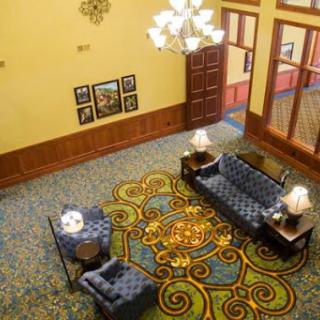 A cozy hotel lobby featuring elegant furniture and decorative elements.