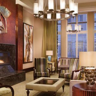A modern living room featuring a cozy fireplace, stylish furniture, and elegant lighting.