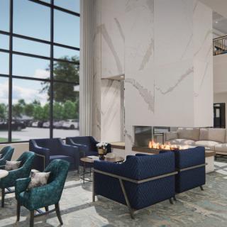A modern lobby with comfortable seating and a fireplace.