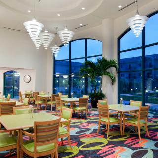 A modern restaurant interior with vibrant colors and decorative lighting.