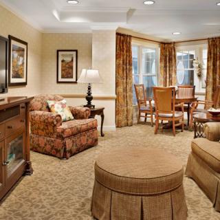 A cozy living room with classic furnishings and a dining area.