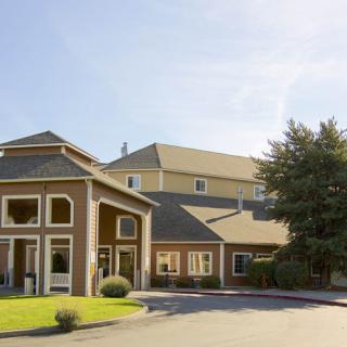A hotel building with a clear blue sky in the background.