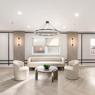 A modern lounge area featuring sleek furniture and contemporary lighting.