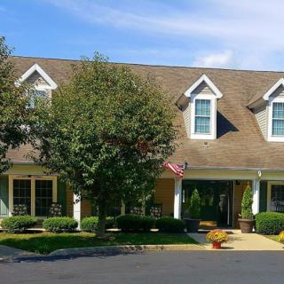 A two-story house with a gabled roof and neatly landscaped front yard.