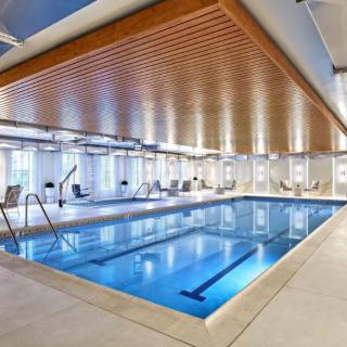 A luxurious indoor swimming pool with modern design and relaxation area.