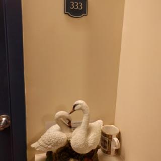Charming entrance featuring decorative swans and room number 333.