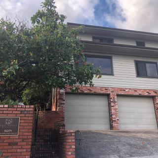 A two-story residential house with a brick facade and a double garage.