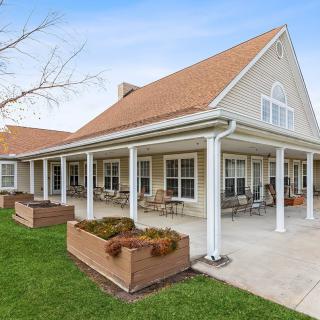 A single-story house with a spacious porch and well-maintained lawn.