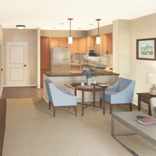 A cozy and modern living space featuring an open layout with a kitchen and comfortable seating.
