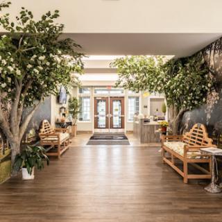 A welcoming lobby featuring lush greenery and comfortable seating, creating a serene atmosphere.