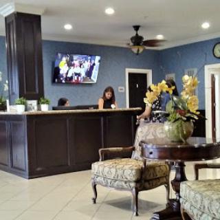 A welcoming lobby with a reception desk, comfortable seating, and modern decor.