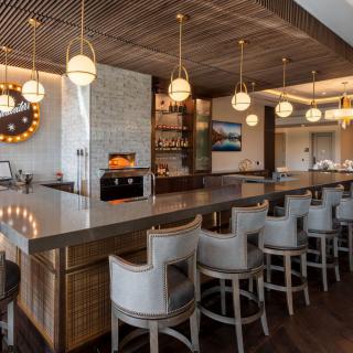 A modern bar interior with stylish seating and warm lighting.