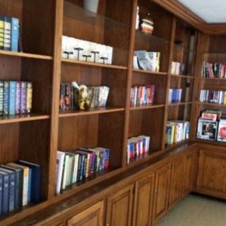 A cozy library with wooden shelves filled with books.