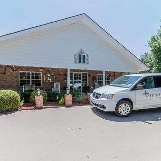 A van parked in front of a building on a sunny day.