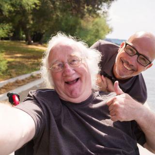 Two friends taking a joyful selfie outdoors.