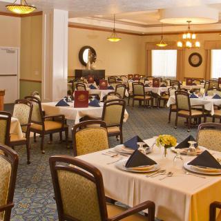 An elegant dining room with neatly arranged tables and chairs.