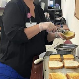 A person preparing cheese sandwiches in a kitchen setting.