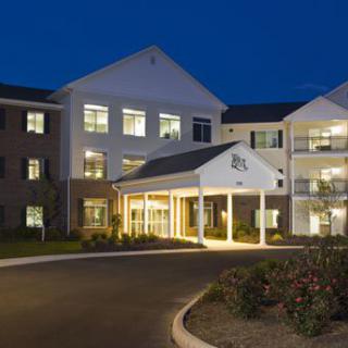 A well-lit residential building entrance at night.