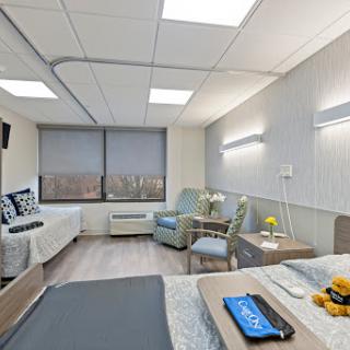 A modern and comfortable hospital patient room, featuring a welcoming atmosphere with natural light.