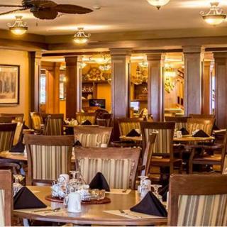 An elegant restaurant interior with neatly arranged tables and chairs.