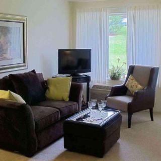 A cozy living room with a sofa, television, and modern decor.