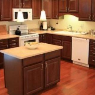 A modern kitchen with wooden cabinets and a central island.
