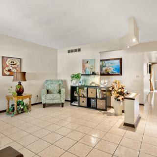 A well-decorated living room with modern furniture and artwork on the walls.