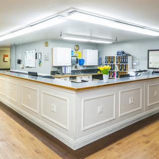 A well-lit reception area with a central desk and organized workspace.