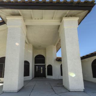 An exterior view of a building entrance with large columns.
