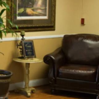 A cozy corner with a leather armchair, small table, and decorative elements.