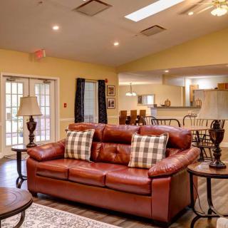 A cozy living room with a brown leather sofa and elegant decor.