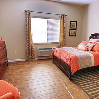 A cozy and well-decorated bedroom with a large bed and a bright window.