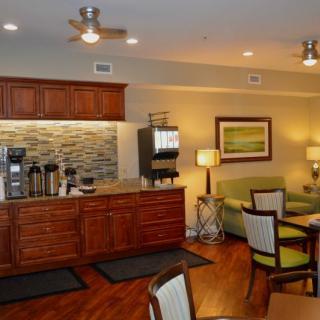A cozy kitchenette with a coffee station and a small seating area.