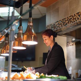 A chef preparing food in a professional kitchen.