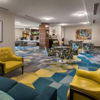 A modern lobby with colorful carpet and stylish seating arrangements.