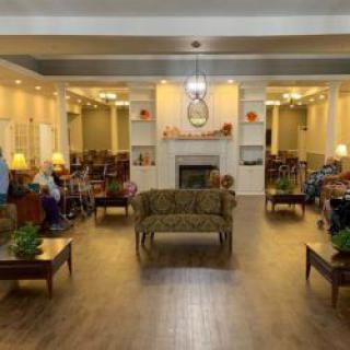 A cozy living room with comfortable seating, elegant decor, and a fireplace.