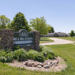 Entrance sign for Oak Hill Estates surrounded by well-maintained landscaping.