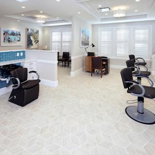 A spacious and modern hair salon interior with stylish barber chairs and a welcoming atmosphere.