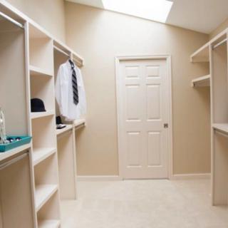 A neatly organized walk-in closet with ample shelving and hanging space.