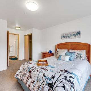 A cozy bedroom with neatly arranged bedding and tasteful decor.