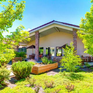 A charming house surrounded by lush greenery and a well-maintained garden.
