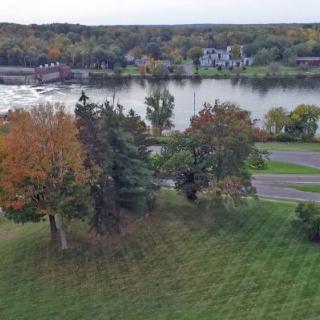A scenic view of a river surrounded by trees in autumn colors.