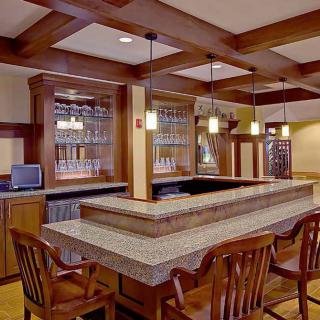 A cozy bar area with wooden furniture and ample lighting.