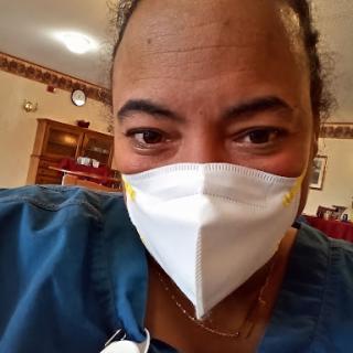 A healthcare professional wearing a mask, ready to provide care.