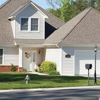 A suburban house with a well-maintained lawn and attached garage.